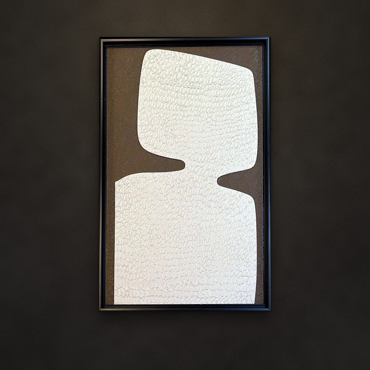 Alabaster ivory monolith relief panel on a charcoal wall