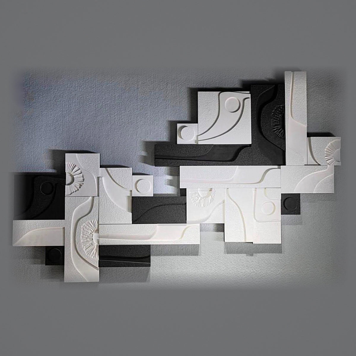 Noir Composition monochrome modular relief installation on a grey gallery wall