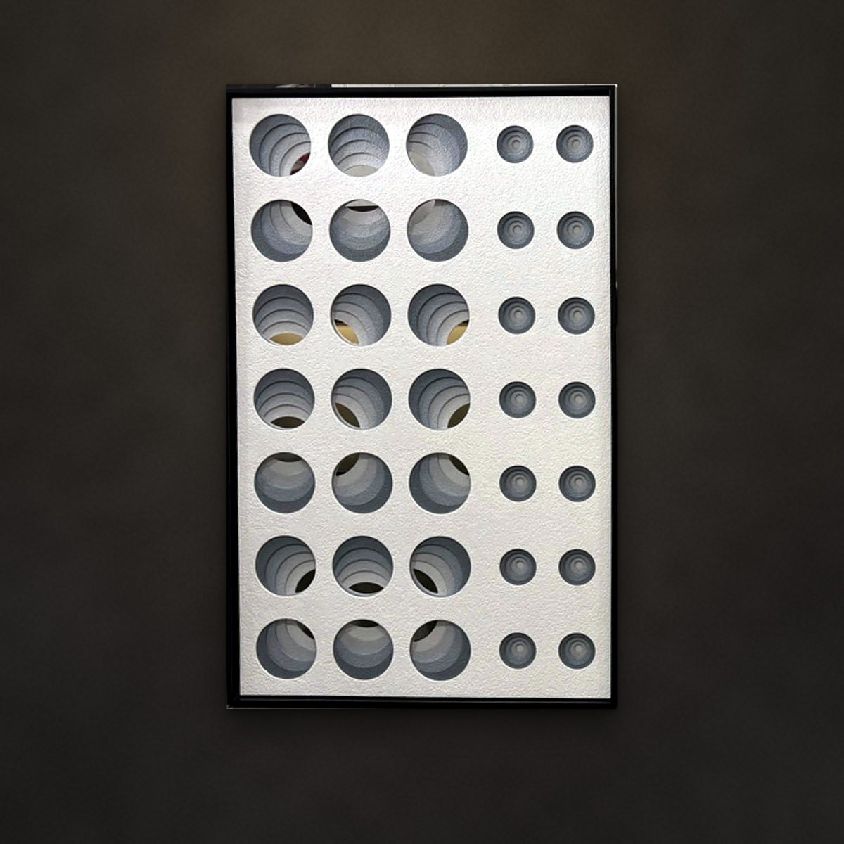 Orbit sculpted relief panel on a charcoal wall
