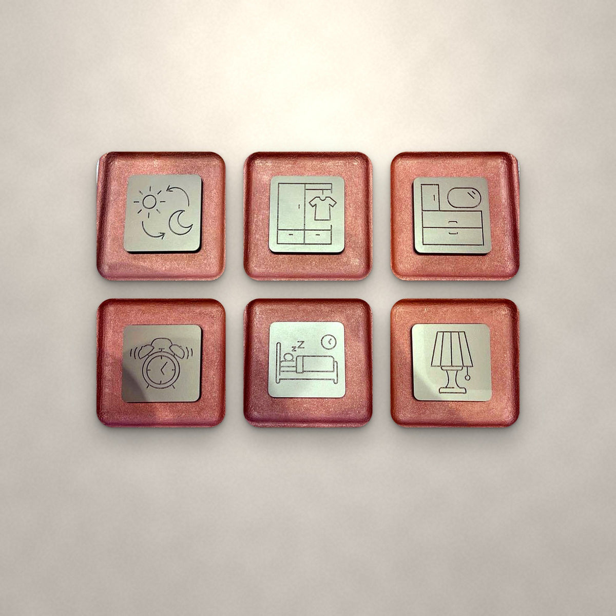 Reverie set of six relief trays in Terracotta & Sand on an ivory wall