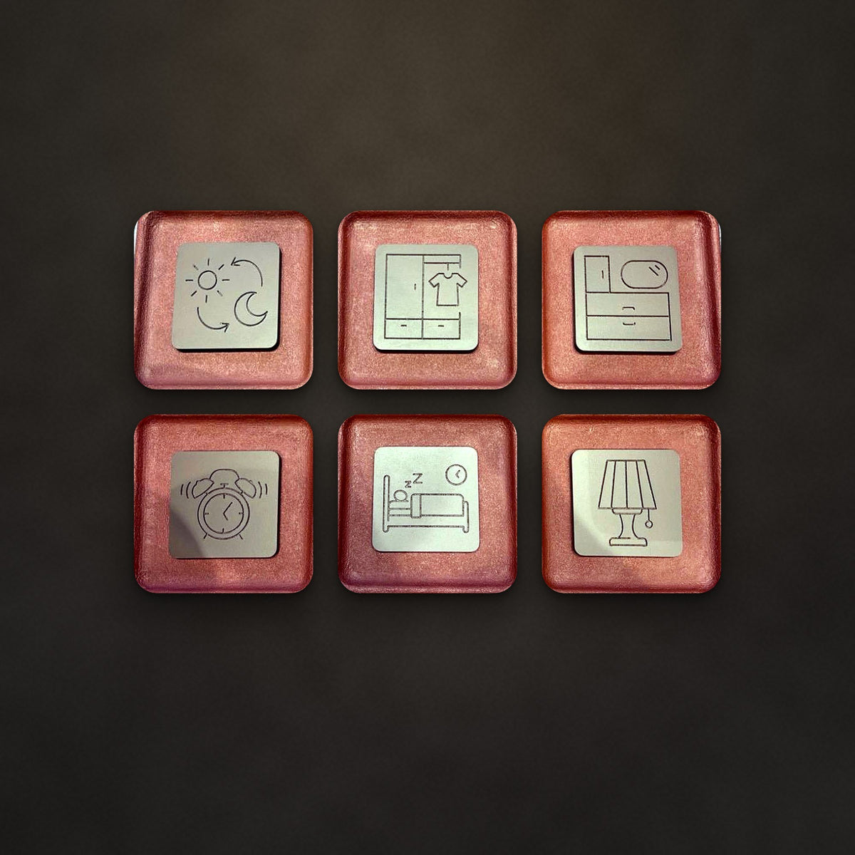 Reverie set of six relief trays in Terracotta & Sand on a charcoal wall